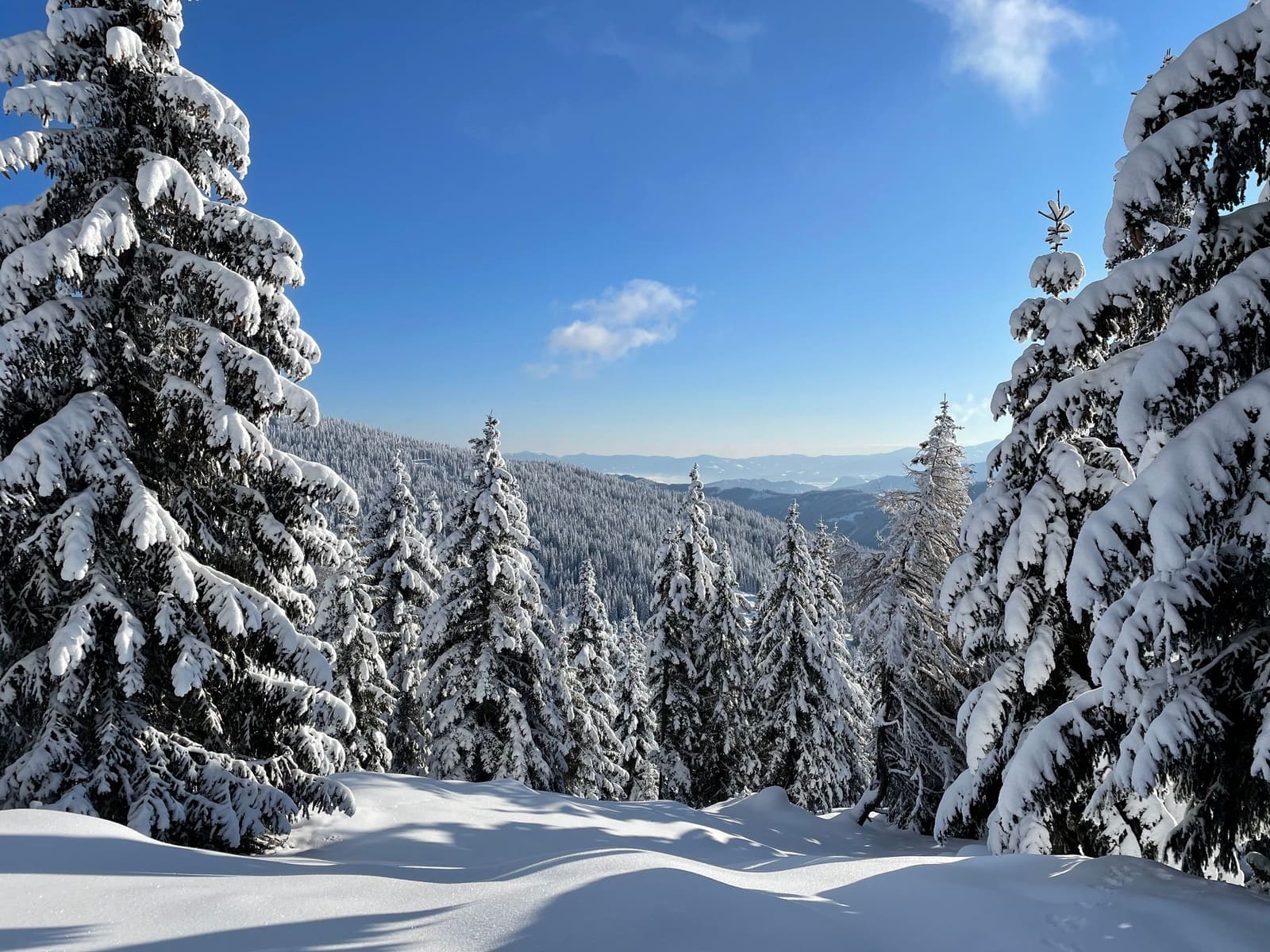 Snowy mountain landscape with ski slope in Styria